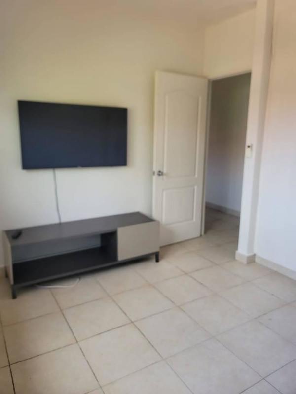 Kitchen with granite countertop, stove, and wood cabinets in PH Versalles Panama City