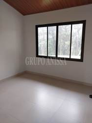 Lush green lawn bordered by dense forest backyard mountain house Panama