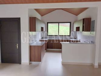 Spacious living room with sliding doors leading to terrace mountain property Altos del María Panama