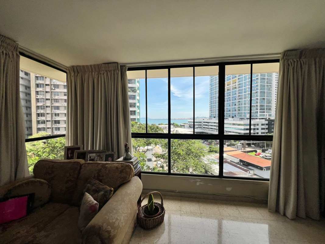 Formal dining room with chandelier and wood furniture in Marbella ocean view apartment for sale