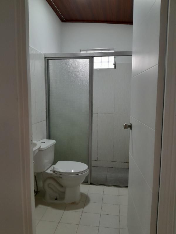 Spacious living room with ceramic tiles, wood-paneled ceiling, natural light Panama City