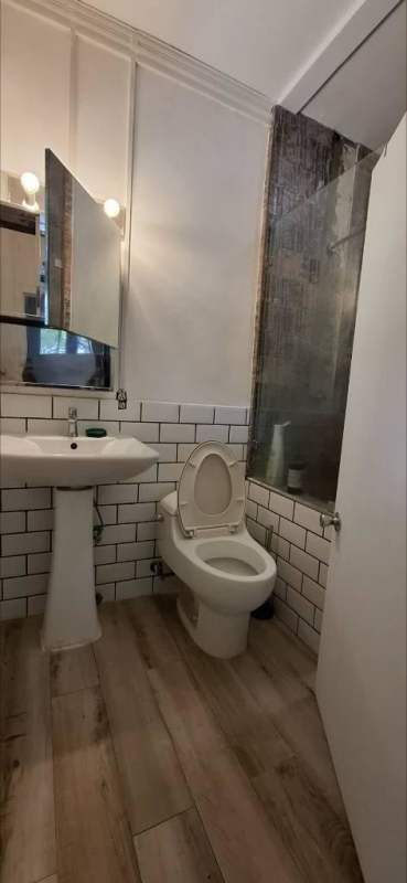 Dining area with wooden table chairs large window Curundu Heights Panama Studio Apartment