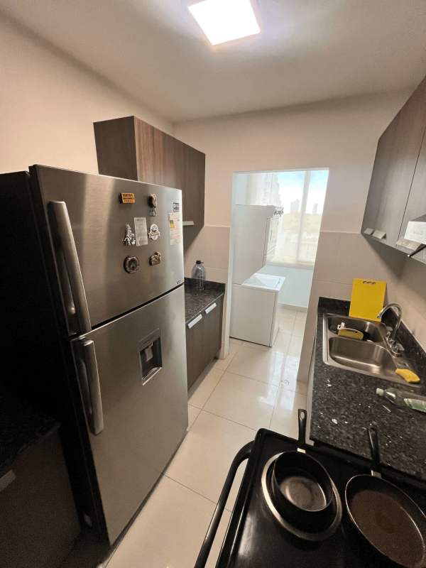 Modern open-concept living and dining area with tile floors and large window PH Taurus Tower Panama