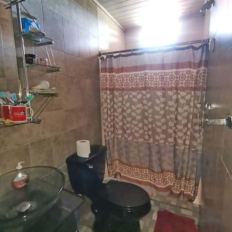 Bedroom with window and tiled floor in spacious house Las Cumbres Panama