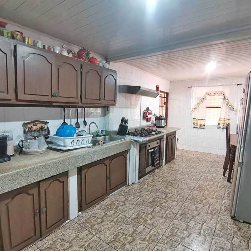 Kitchen area with cabinets and tiled counters in Chivo Chivo home