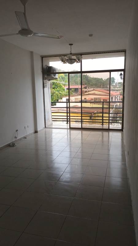Bright living area with large sliding window, balcony, tile flooring, ceiling fan in Villa de las Fuentes