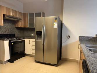 Swimming pool with sun deck surrounded by gardens in PH Embassy Village Clayton