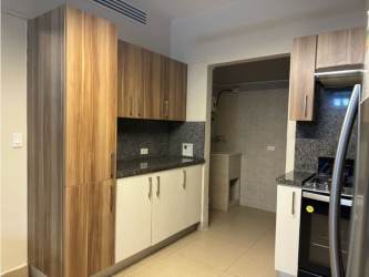 Kitchen with granite counter, stainless appliances, wood cabinets in PH Embassy Village