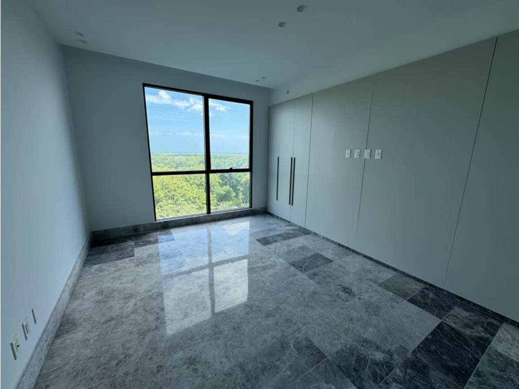Open-concept living room with marble floors and panoramic windows in Empire Residences Santa María Panama