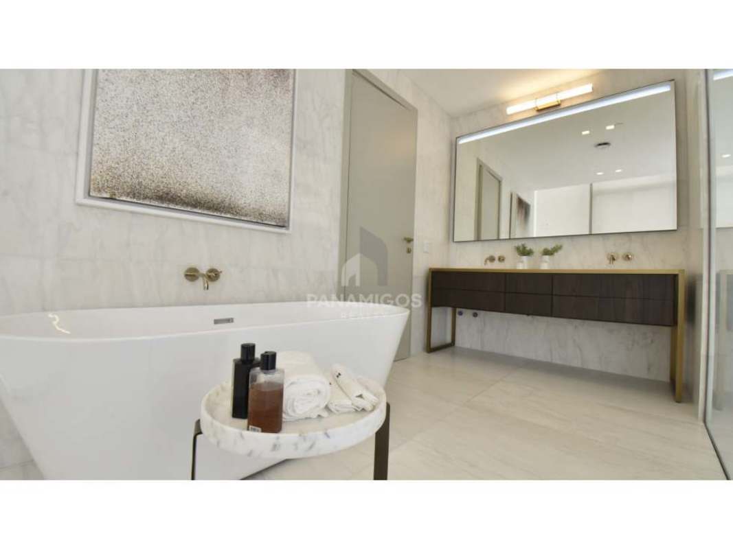 Contemporary dining and living room floor to ceiling windows round table pendant lights Santa María Panama