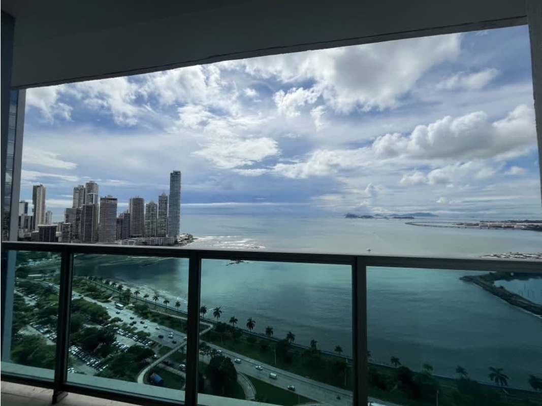 Bright living room with floor-to-ceiling windows overlooking ocean at PH Yoo Panama