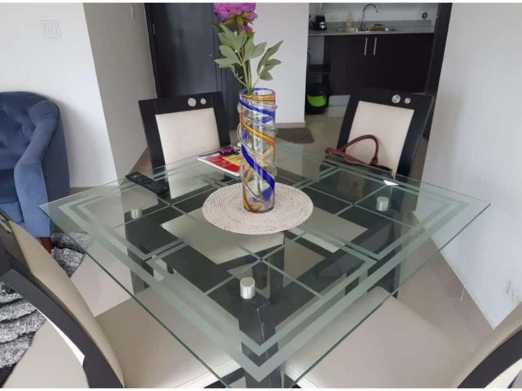 Modern dining area with glass table and open kitchen in PH Sky Park Panama City