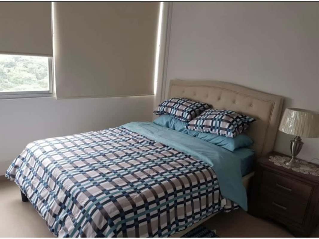 Second bedroom with tufted headboard and wardrobe in PH Sky Park Carrasquilla Panama