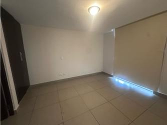 Outdoor swimming pool surrounded by loungers and garden in PH Mosaic Panama Pacifico