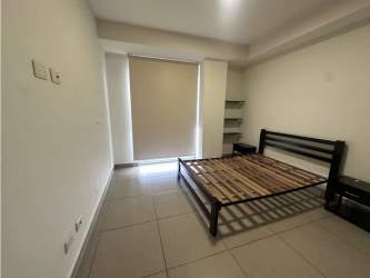 Bedroom with large window and built-in closet PH Mosaic Panama Pacifico apartment