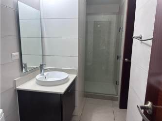 Modern bathroom with vessel sink, glass shower, tiled walls PH Mosaic Panama Pacifico