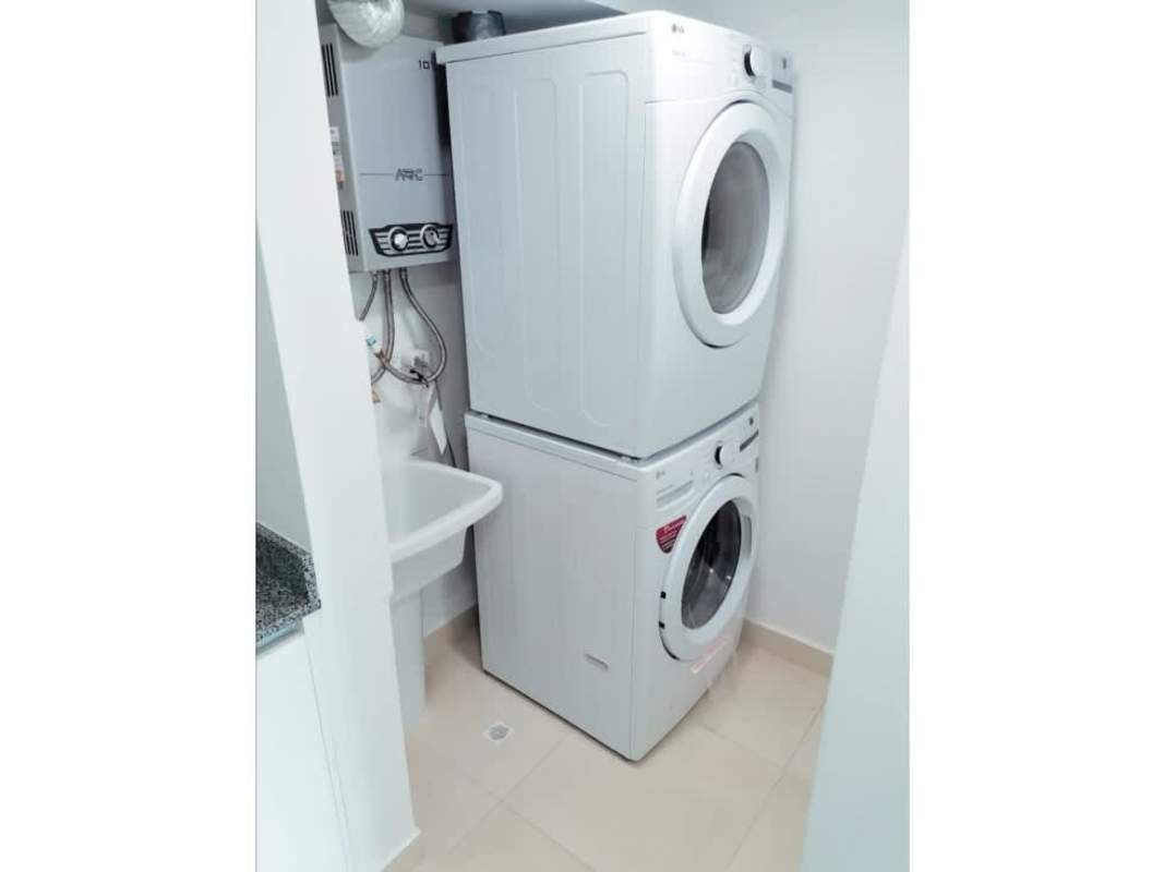 Compact laundry with stacked washer dryer and water heater in PH Panamá Residences Panama City