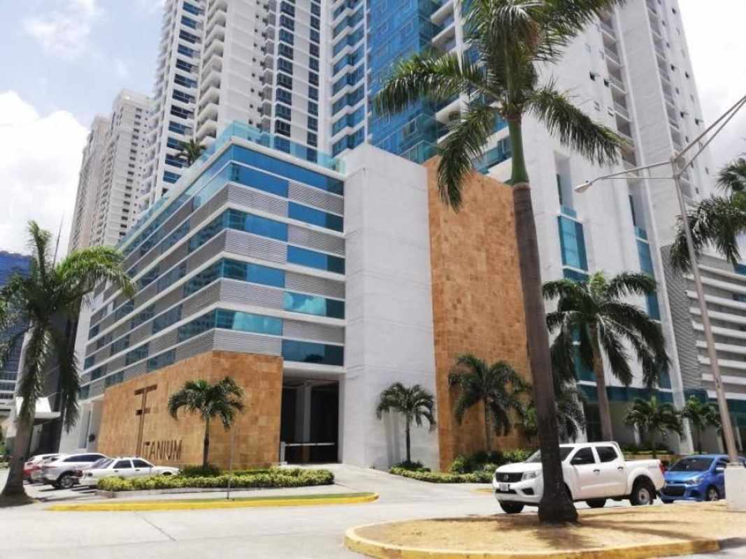 Exterior of luxury condominium tower PH Titanium with glass facade palm trees in Costa del Este Panama City