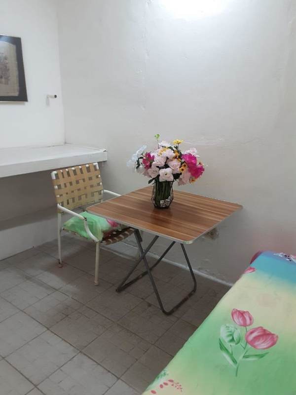 Cozy indoor dining or lounge with folding table, chair, floral decoration Betania Panama