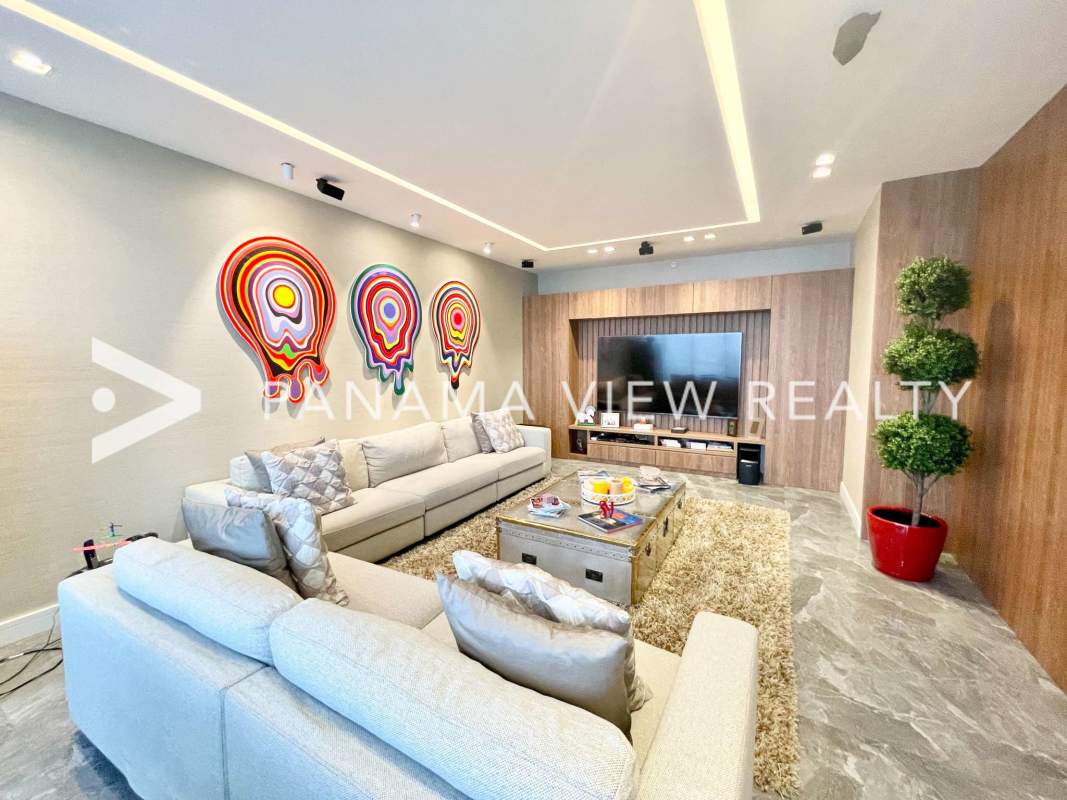 Spacious living room with marble floors, floor-to-ceiling windows, ocean and skyline views at PH Regalia Costa del Este