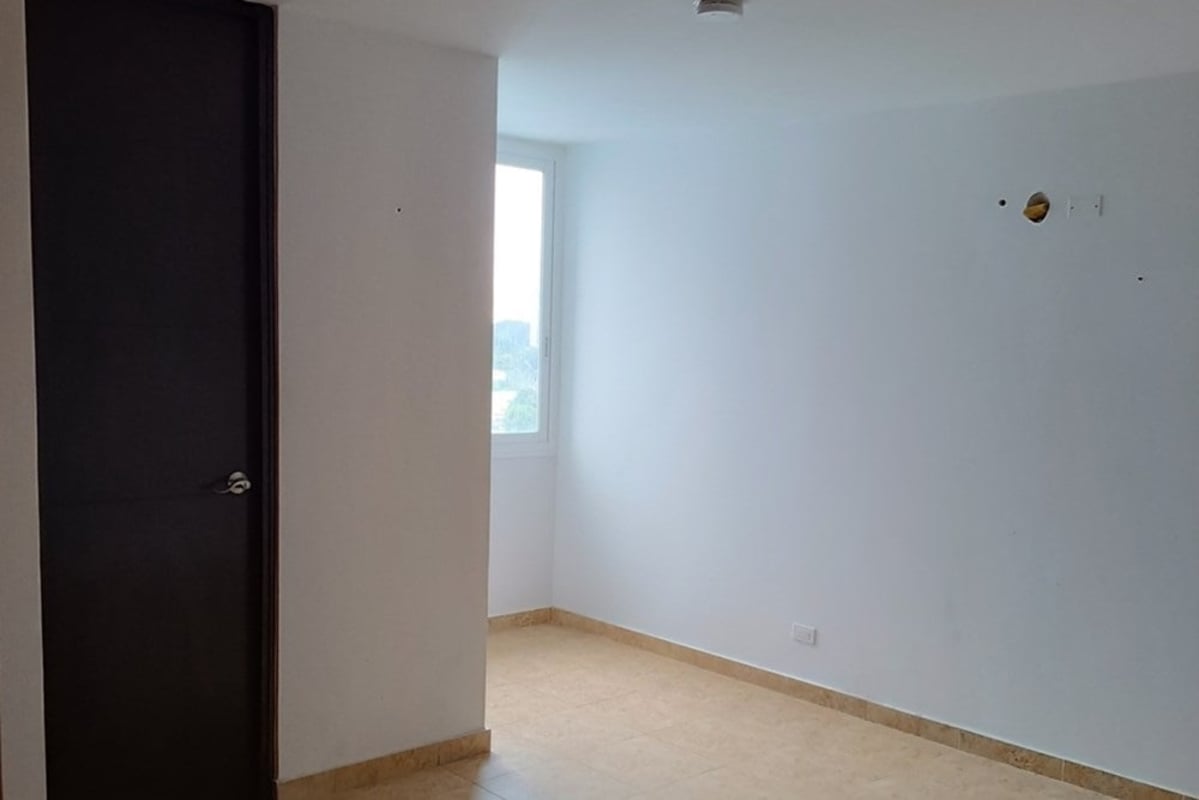 Bright minimalist bedroom white walls large window PH Torre El Dorado Panama