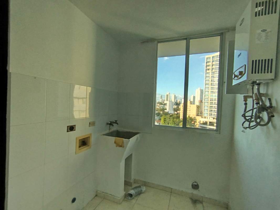 Laundry area with utility sink and city view window PH Hyde Park Panama