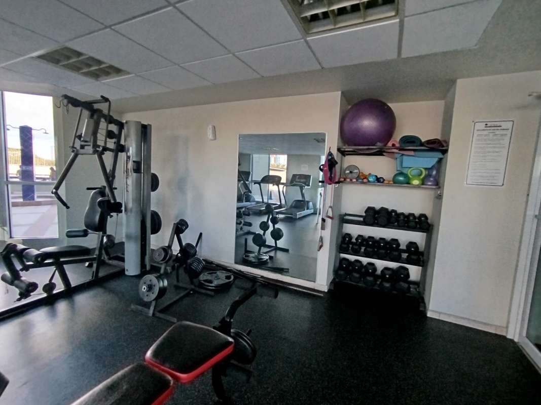 Condominium gym with cardio equipment, large windows and skyline view HYDE Park Panama