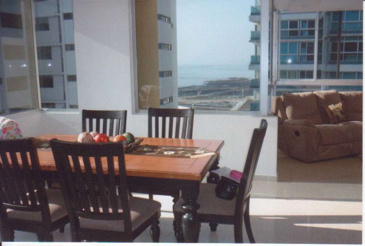 Dining space with large windows and ocean view at PH Bahia Marbella 2 Panama City