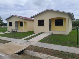 Compact open kitchen space with black cabinets and tiled hallway in Milla de Oro Rio Hato Coclé Panama