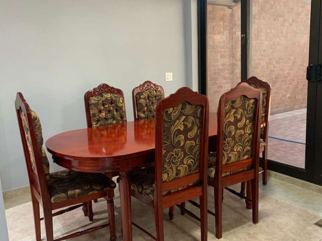 Elegant double wood front doors with iron décor and plants at Brisas del Golf House Panama