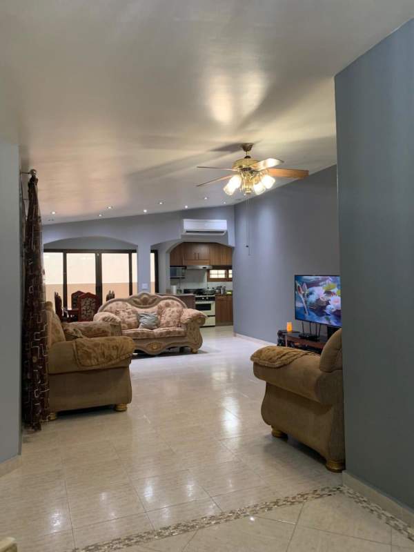 Open-concept living and dining room with ceramic tile floor and patio access - Brisas del Golf Panama