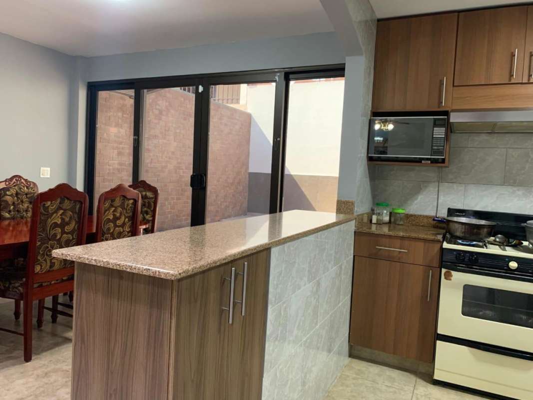 Kitchen with granite countertop breakfast bar open to dining space house for sale Brisas del Golf Panama