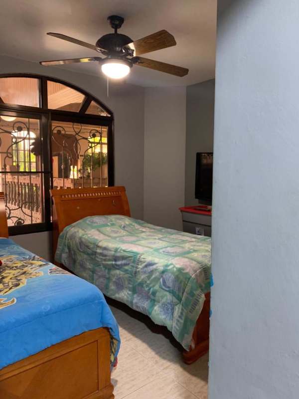 Kitchen with granite, wood cabinetry, sliding glass doors to patio in Brisas del Golf Panama