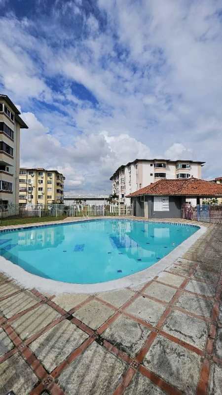 Outdoor swimming pool with paved deck in Parques del Este residential complex Panama City