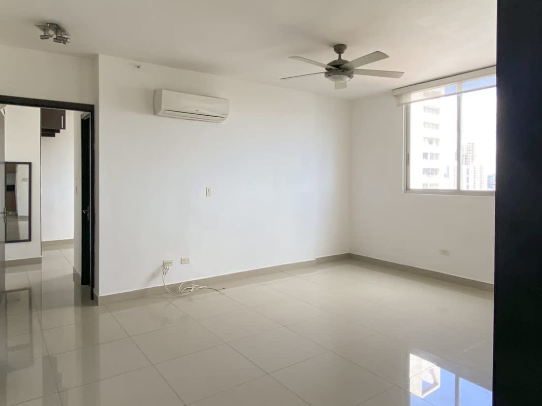 Bright empty modern living room with split AC, large windows, and porcelain tile floors in PH 65 Tower San Francisco Panama