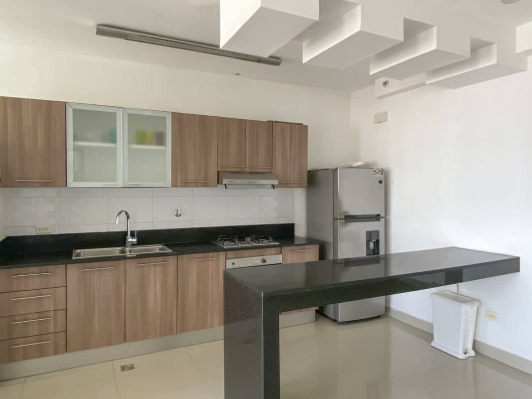 Modern kitchen with granite countertops, wood cabinetry, appliances PH 65 Tower San Francisco Panama