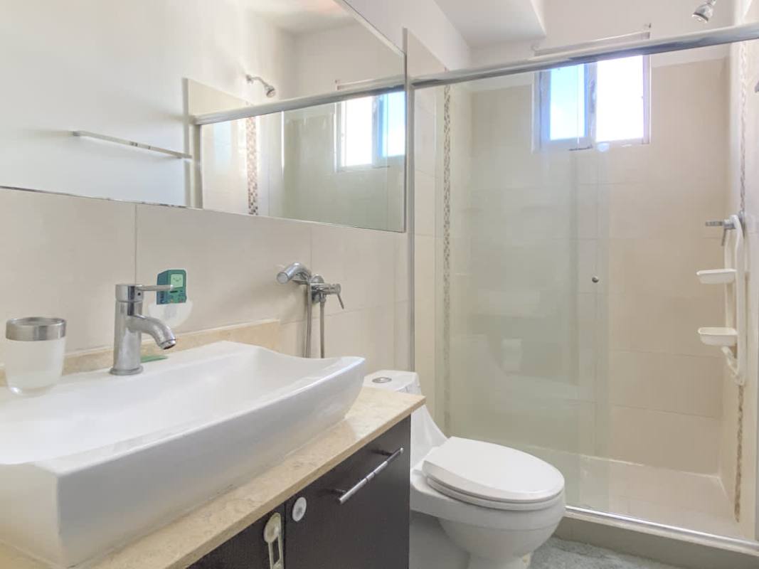 Contemporary bathroom with glass shower, vanity, and natural light window PH 65 Tower San Francisco Panama