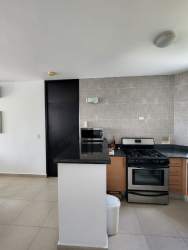 Fully equipped kitchen in Playa Blanca beach apartment with granite and appliances