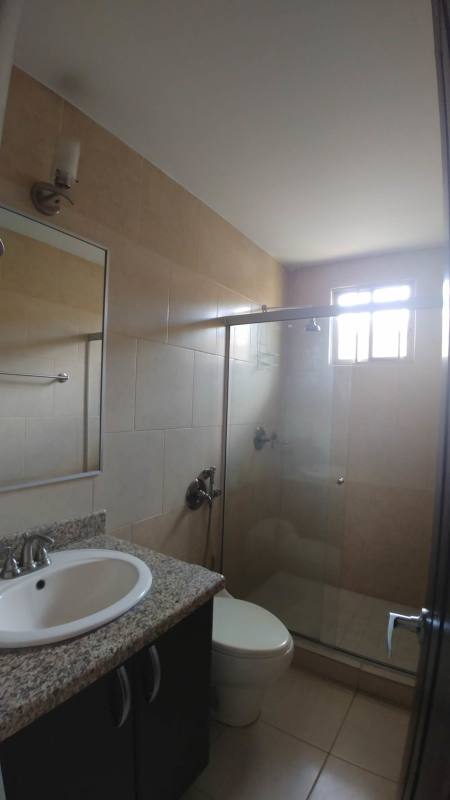 Modern bathroom double vanity, granite, glass shower Condado del Rey house Panama