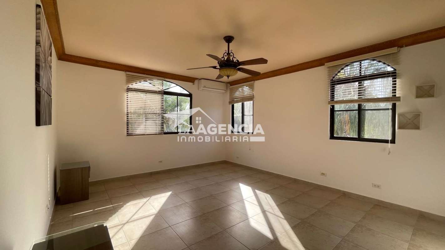 Spacious covered patio with ceiling fans overlooking lush garden and pool in Clayton Village Panama