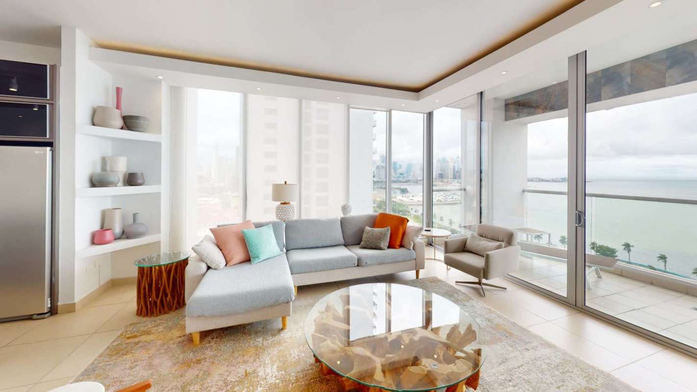 Living room featuring panoramic ocean and city skyline views in PH Rivage Tower Panama