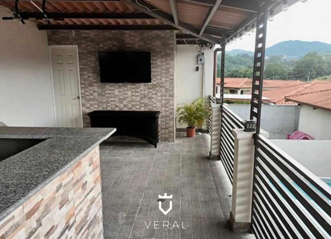 Twilight view of backyard pool and covered patio at PH Vistas del Lago Panama