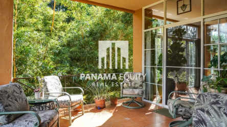 Covered patio space with tropical gardens and outdoor furniture Villa Valencia Altos del Maria