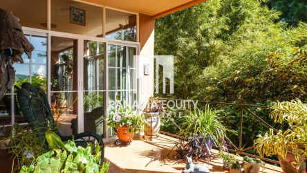 Spacious covered patio with mountain views, terracotta tiles, lush garden Villa Valencia Altos del Maria Panama