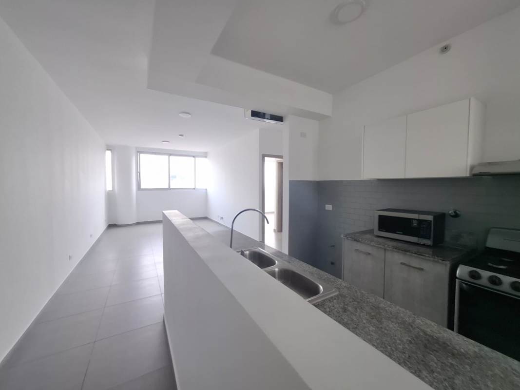 Contemporary semi-open kitchen with granite counters, appliances, natural lighting in PH Signature Point, La Cresta