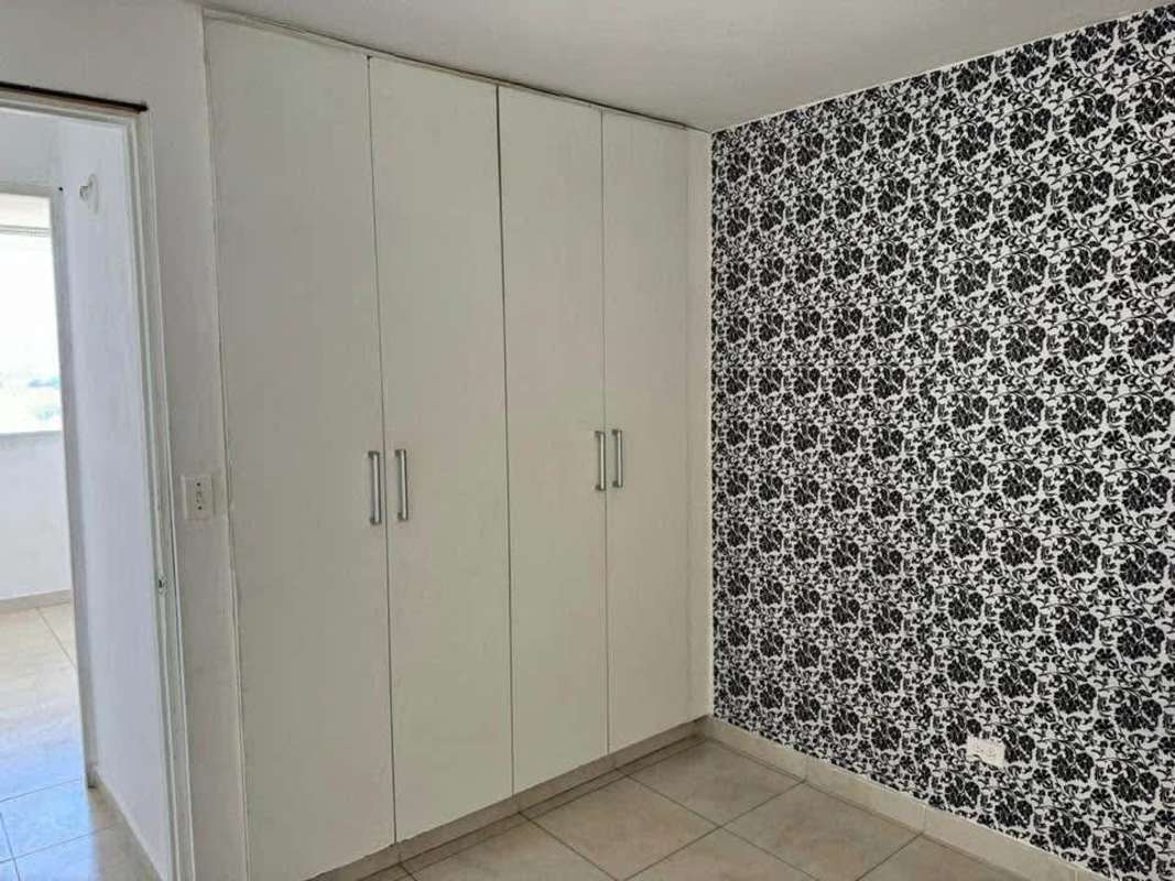 Bedroom featuring built-in wardrobe and black and white wallpaper Mystic Tower Panama City