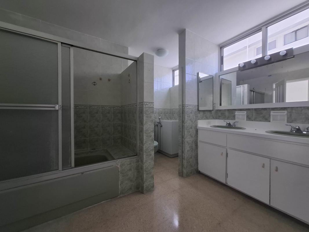 Bathroom with walk-in shower, large vanity and brown tile walls PH Savoy Panama
