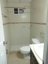 Compact bathroom with ceramic tiles walk-in shower residential rental Vacamonte Panama
