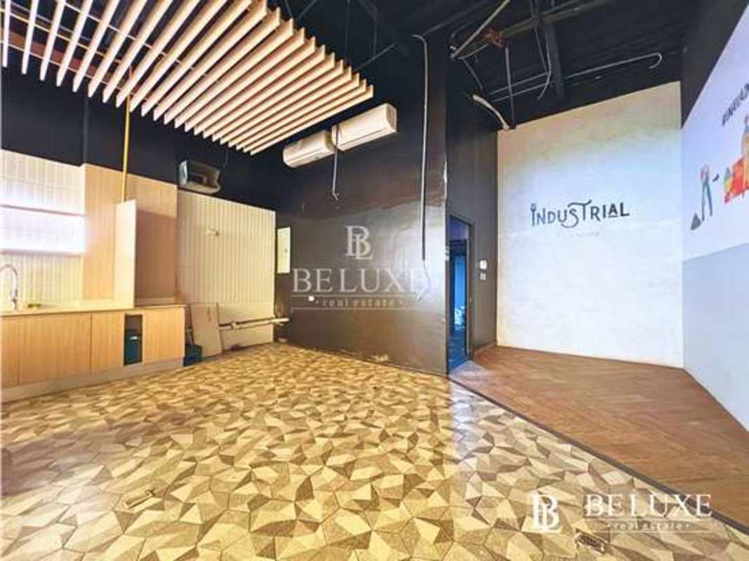 Interior commercial space with industrial design, wood ceiling panels and geometric tiles near Via Porras Panama City