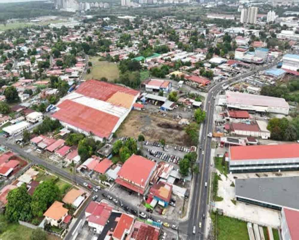 Corporate office with cubicles, fluorescent lighting, tiled floors, inside logistics warehouse Panama City